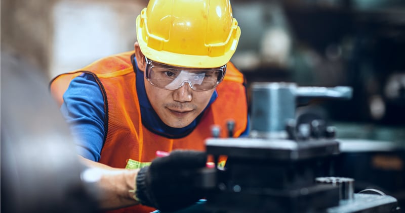 Engineer examining equipment in factory