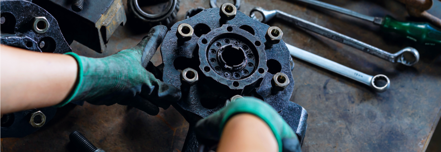 Industrial plant worker repairing car parts