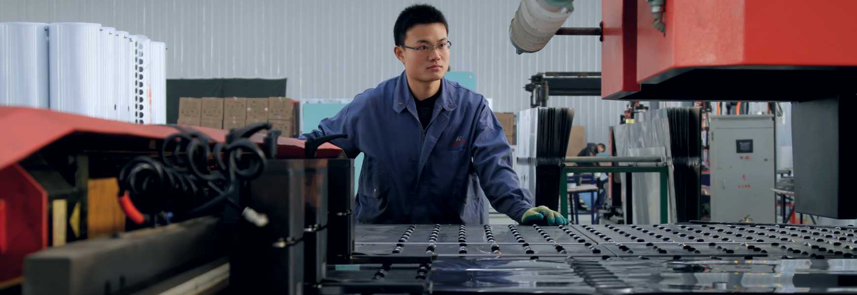 Plant worker inspecting mechanical equipment