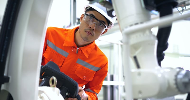 Factory worker checking up on equipment