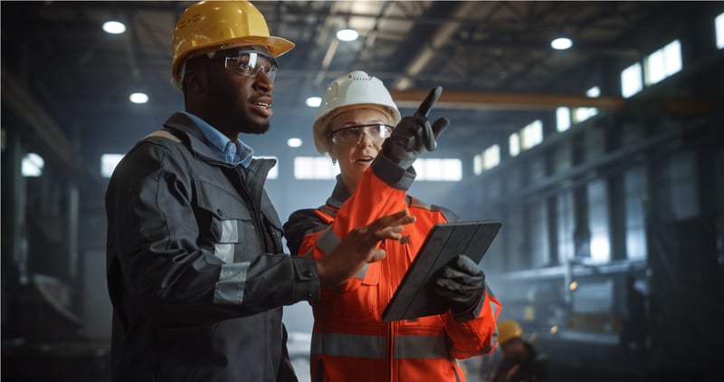 two manufacturers discussing in a factory
