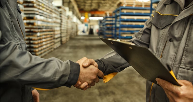 Factory workers shaking hands