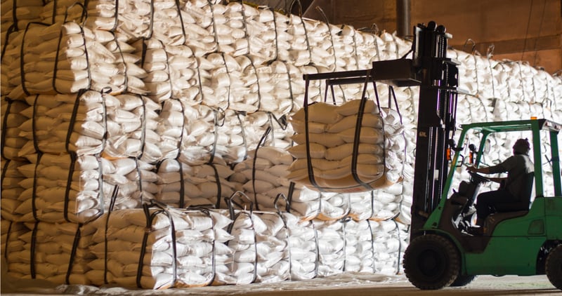 crane holding up raw materials in a sack