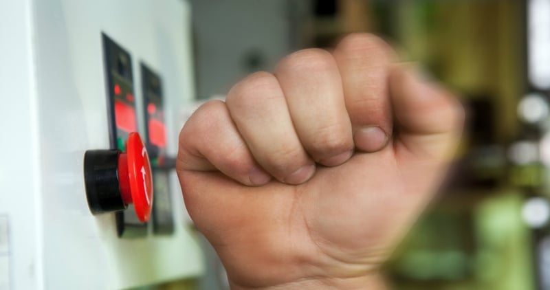 Hand pressing emergency button