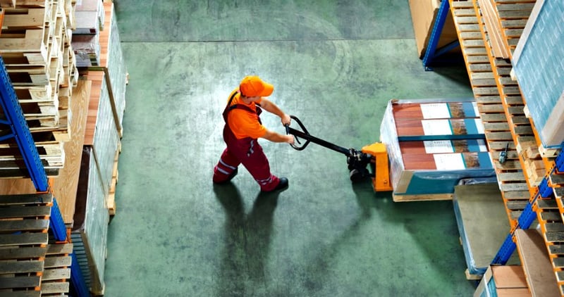 factory worker pushing trolley