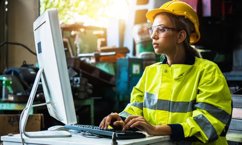 Factory worker looking at computer