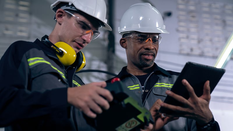 two manufacturing employees having a discussion