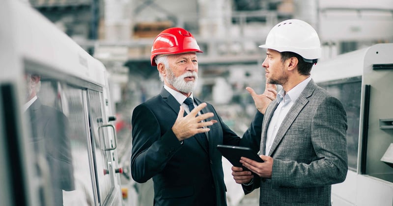 Two men discussing inside a factory