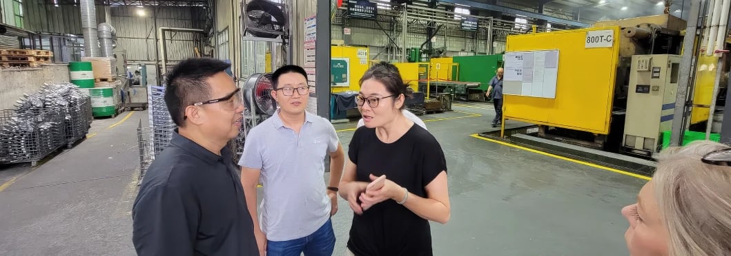 members of MTG discussing inside factory
