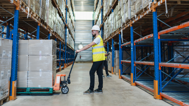 man in factory moving inventory 