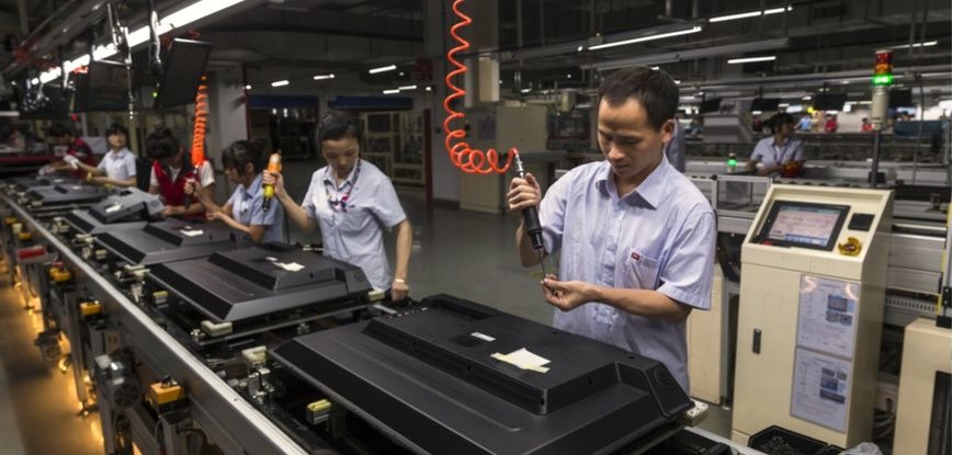 people working on a manufacturing belt