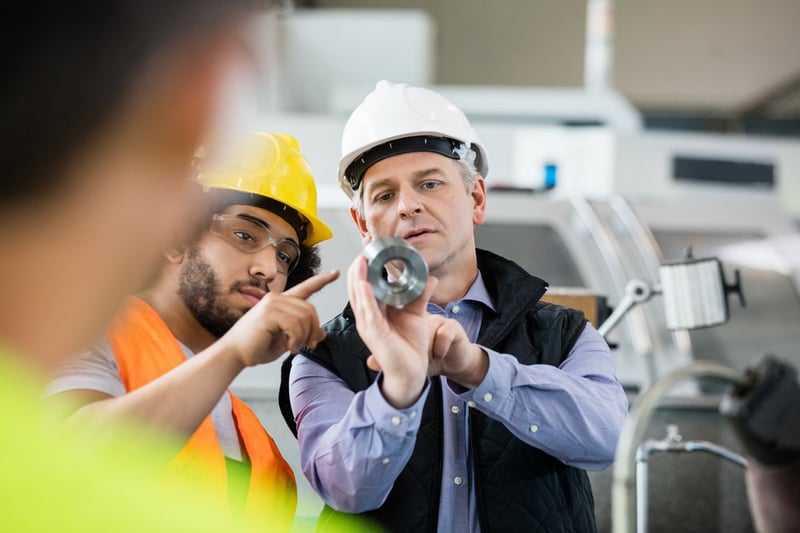 factory workers with equipment