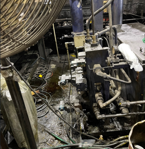 Exposed wiring and tangled components on factory equipment
